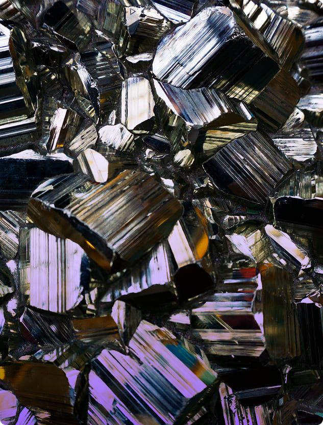 A macro photograph of raw magnesium-rich mineral crystals